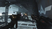 First-person shooter game scene with weapons and character in a futuristic setting