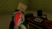 A person in a white outfit and blue gloves sits in a wheelchair with a large cardboard box on their head, covered in red splatter. They are in a dimly lit room with green patterned wallpaper, a wooden table with a chessboard, and a boombox.