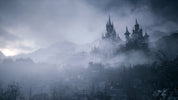 Mysterious castle in the fog with mountains in the background
