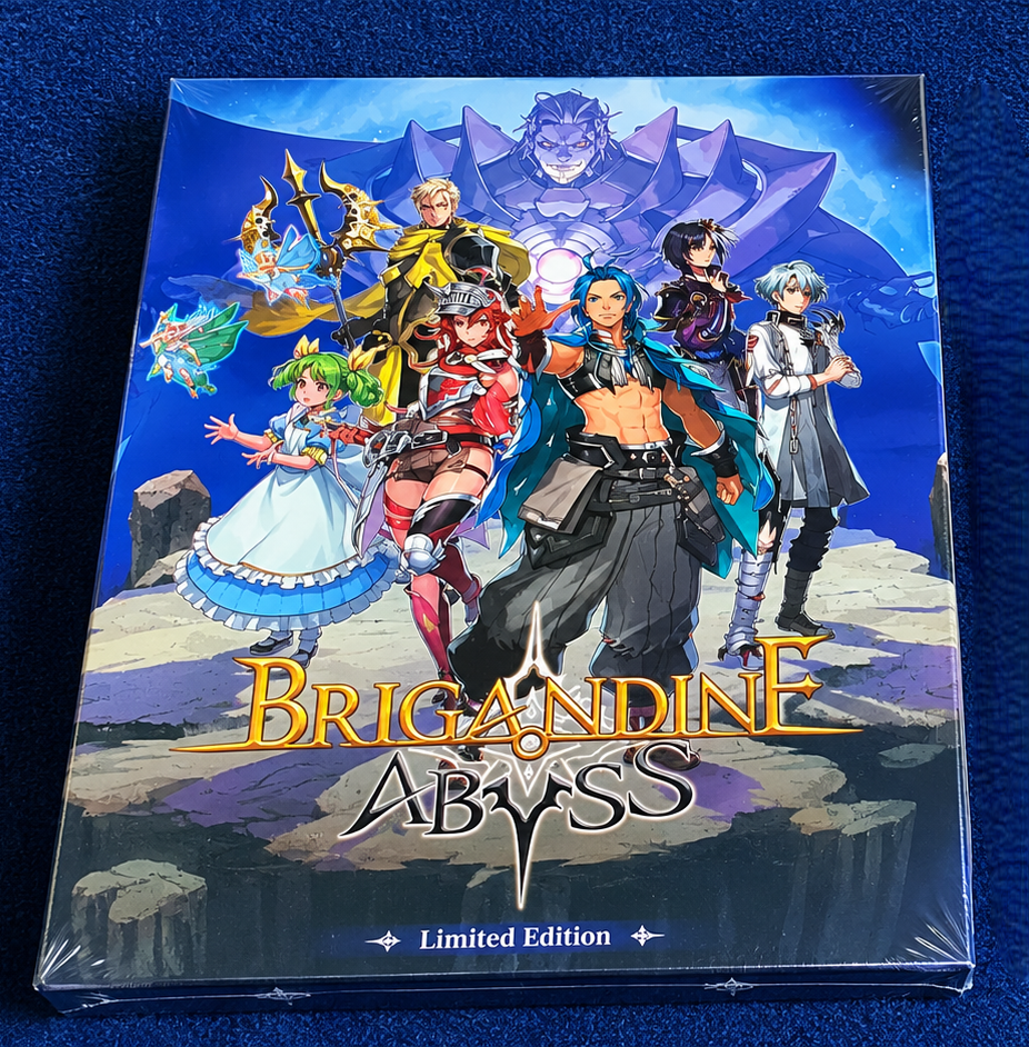 A sealed plastic-shrink-wrapped game box for Brigandine Abyss Limited Edition, photographed from above on a textured dark blue fabric background. The box art features multiple colorful fantasy characters and a large blue title logo.