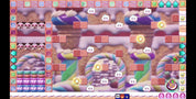 A colorful screenshot from a candy-themed puzzle game, showing a grid with pink candy blocks, rainbow swirls, and small character icons on a pastel background.