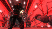 A dark sci-fi scene with a person in black armor standing in a red-lit industrial corridor, facing large spider-like creatures.