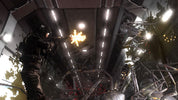 A soldier in dark tactical gear fires a weapon inside a futuristic industrial interior with bright overhead lights and metal structures.