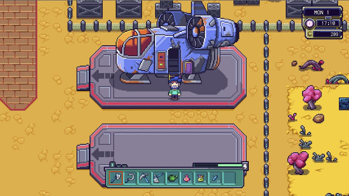 Pixel art style screenshot of a sci-fi vehicle or structure on a platform in a desert-like game scene, with a small character standing in front and an inventory bar at the bottom.