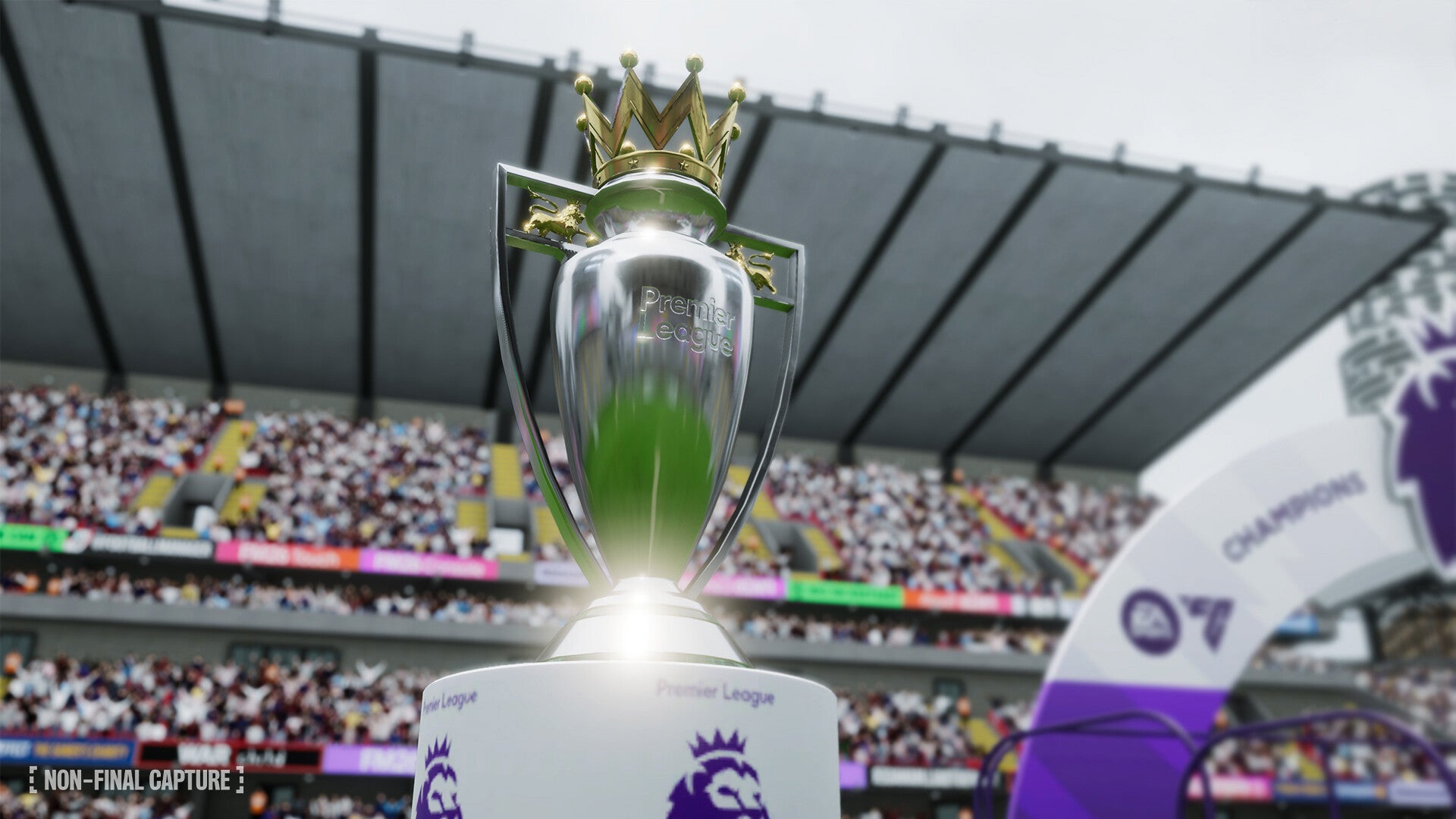 Silver trophy with a green center and crown on top, set against a stadium background.