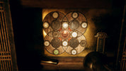 Decorative wall art with circular patterns and lights in a dimly lit room.