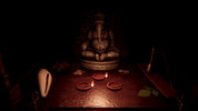 A dark, atmospheric scene featuring a seated Ganesha statue on a wooden table, surrounded by small red clay lamps, a white shell, and incense sticks in a very dim, moody setting.