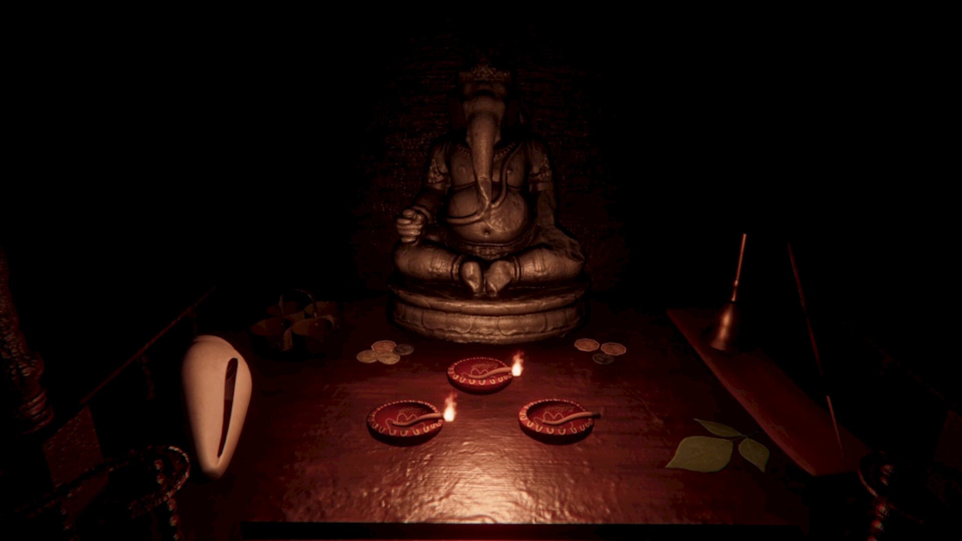 A dark, atmospheric scene featuring a seated Ganesha statue on a wooden table, surrounded by small red clay lamps, a white shell, and incense sticks in a very dim, moody setting.