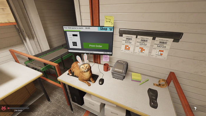 A computer monitor on a desk in a simulated shop environment, displaying an ordering interface with a green 'Print Order' button. A realistic-looking orange cat wearing a white bunny suit and ears sits on the desk next to the monitor, with a computer mouse, keyboard, and other desk accessories around it.