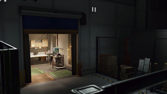 A dimly lit warehouse or industrial interior with a large open overhead door revealing a warmly lit office or room inside. To the right is a fenced storage area with stacked boxes and pallets.