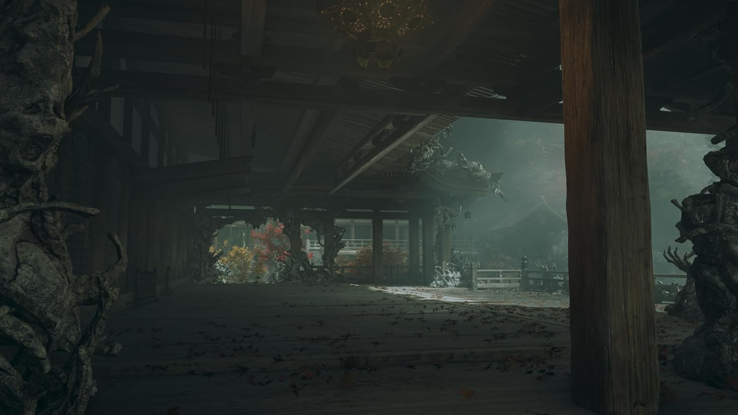 A dark, atmospheric scene inside a traditional wooden structure with a large wooden pillar in the foreground, dusty ground, and a misty outdoor area visible in the distance.