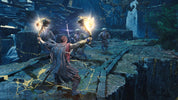 A video game scene showing a character in a dark, rocky forest-like environment holding glowing maces, with other figures and a white-robed figure in the background.
