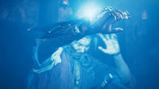 A dramatic blue-lit scene showing a person in dark clothing with glowing hands and a bright light source between them, set against a dark atmospheric background.