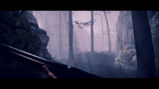 Misty forest scene with rocks and trees, viewed through a rifle scope.