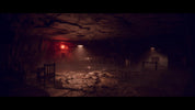 Dark, eerie room with red light and wooden furniture