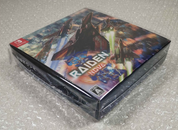 Video game console with 'Raiden' branding on a gray surface