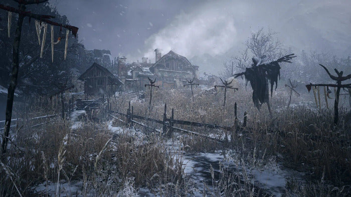 Frozen landscape with wooden houses, fences, and scarecrows in a snowy setting.