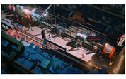 A high-angle digital illustration of a futuristic sci-fi city street scene at night, featuring trains, vehicles, and small characters with dramatic neon lighting.