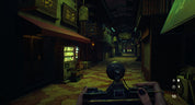 A first-person perspective in a dark, narrow alleyway with storefronts on both sides, viewed from behind a character holding a black device. The scene is dimly lit with warm yellow and orange tones from the floor and shop lights, with Japanese signage visible on the buildings.