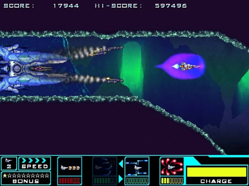 A screenshot from a retro space shooter video game, showing a blue futuristic spaceship firing at a purple enemy ship in a neon-lit tunnel. The top displays a score and high score, and the bottom features a colorful user interface with speed, stars, and charge indicators.