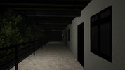 Dark hallway with railing on the left and windows on the right wall.