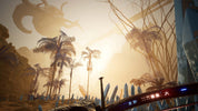 Sunset over a desert landscape with palm trees and a large creature silhouette.