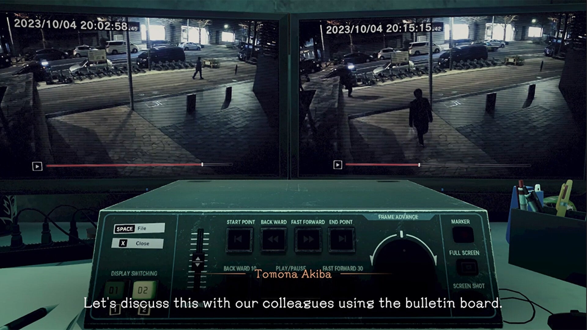 Video surveillance system interface with two monitors displaying a street scene at night.