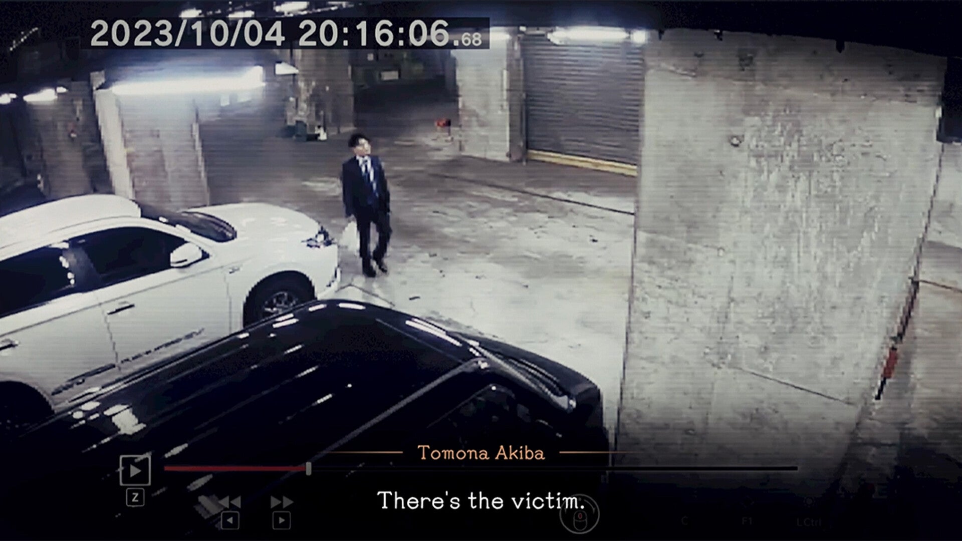 Person in a suit standing in a dimly lit garage with cars, timestamp and name displayed.