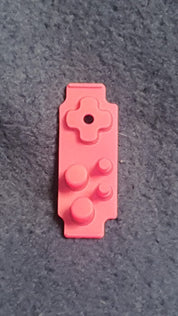 Pink toy brick on a gray surface