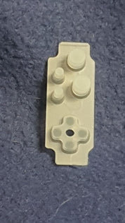 White plastic component on a textured gray background