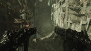 First-person view of a character holding dual weapons in a dark, post-apocalyptic alleyway.