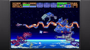 Vintage video game screen showing a space shooter with spacecraft and Earth in the background.