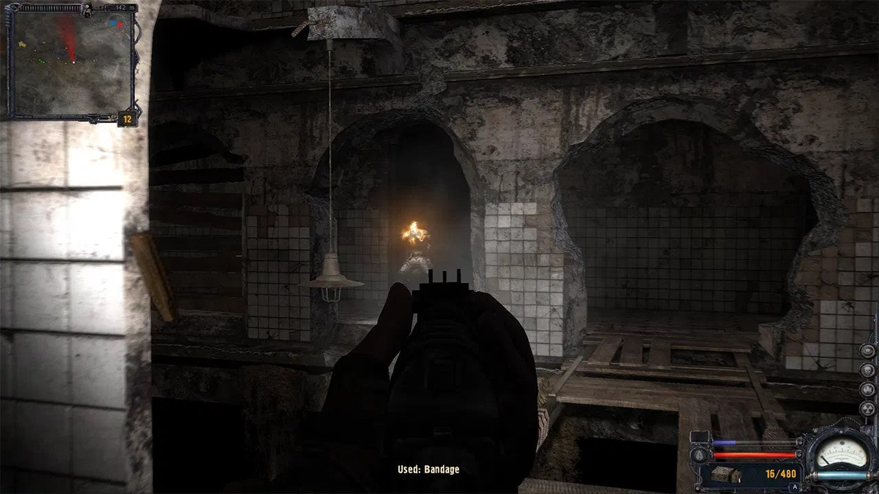 Dark, eerie interior with a character holding a weapon and a light source.